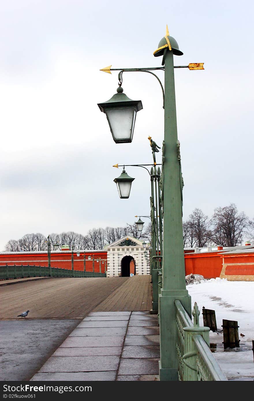 Peter and Paul Fortress, the bridge with lights, a fence on the bridge, dove, the entrance to krepos, the gate to the fortress, a symbol of Russia, a symbol of St. Petersburg