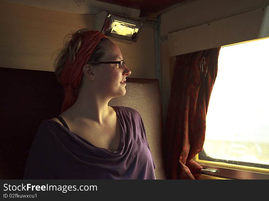 Young woman traveling through India with a train.