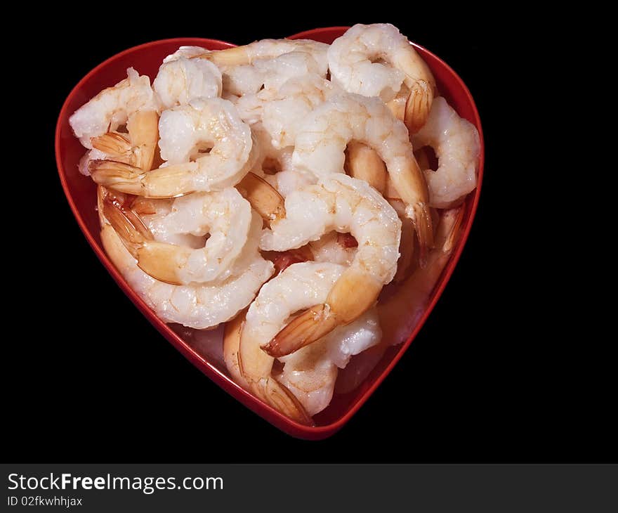 Cocktail Shrimp in heart shape red bowl. Isolated on Black background. Cocktail Shrimp in heart shape red bowl. Isolated on Black background.