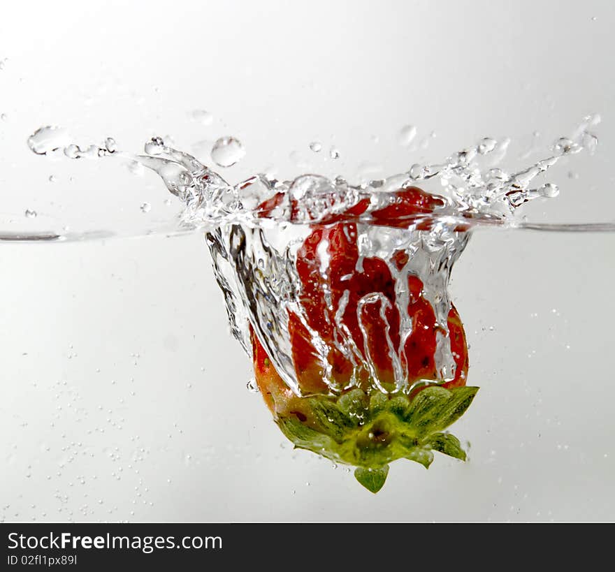 A close-up shot of strawberry splash in water