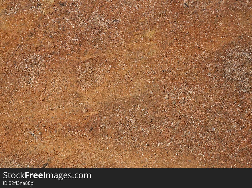 A Macro photograph of reddish hard sandy soil. A Macro photograph of reddish hard sandy soil