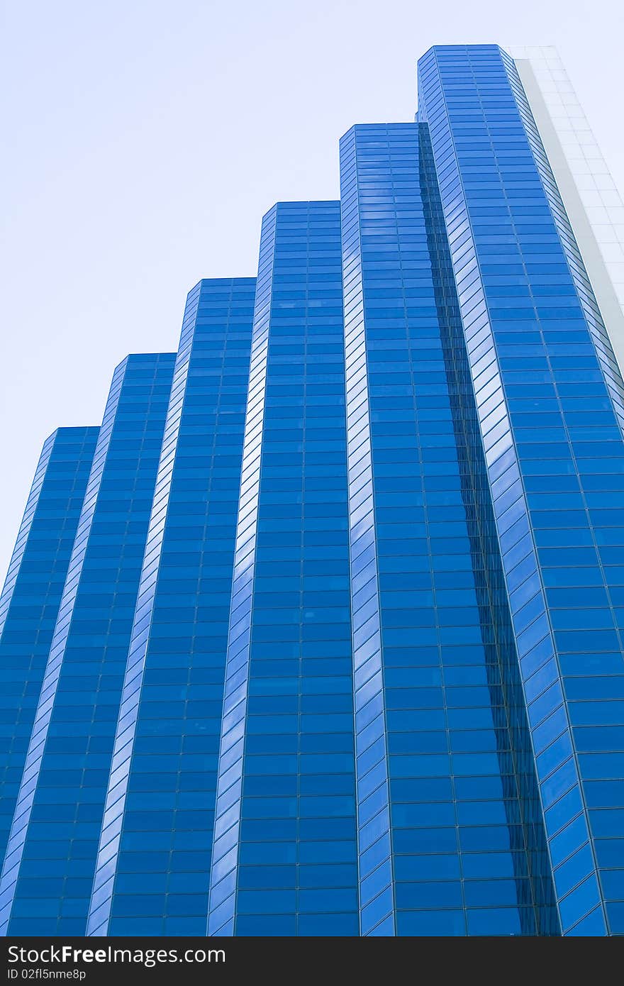 It's virtually a rising of blue bars...Actually, i'ts a blue-mirror building located in the city of Perth, WA. It's virtually a rising of blue bars...Actually, i'ts a blue-mirror building located in the city of Perth, WA.