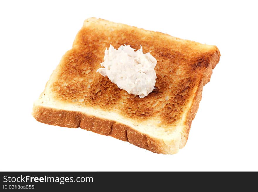 A piece of baked bread with mayonnaise tuna isolated on white background. A piece of baked bread with mayonnaise tuna isolated on white background.