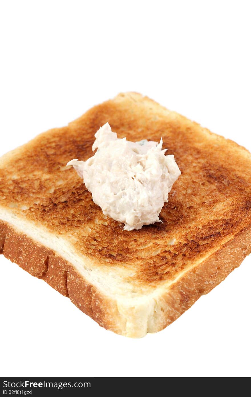 A piece of baked bread with mayonnaise tuna isolated on white background. A piece of baked bread with mayonnaise tuna isolated on white background.