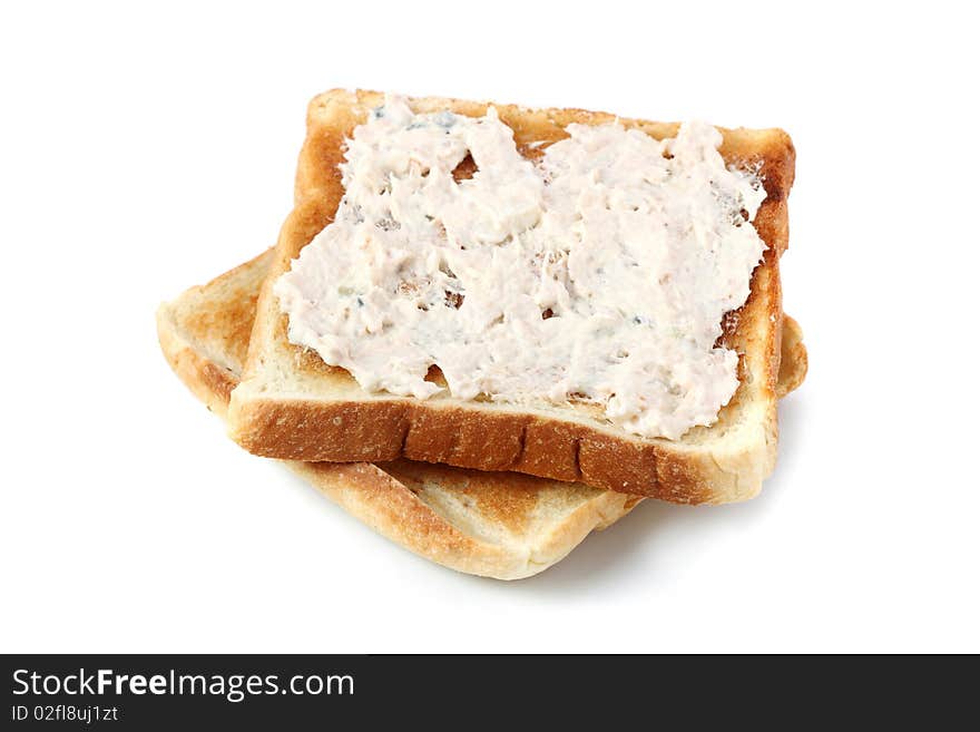 A piece of baked bread with mayonnaise tuna isolated on white background. A piece of baked bread with mayonnaise tuna isolated on white background.