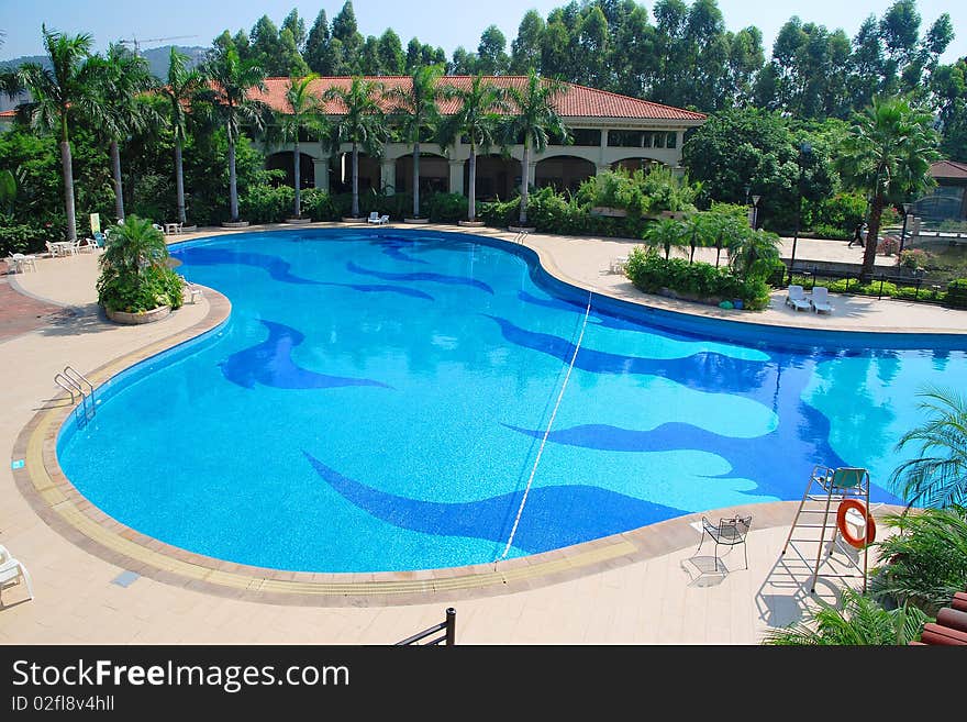 Sunny summer day large swimming pool in the hotel.