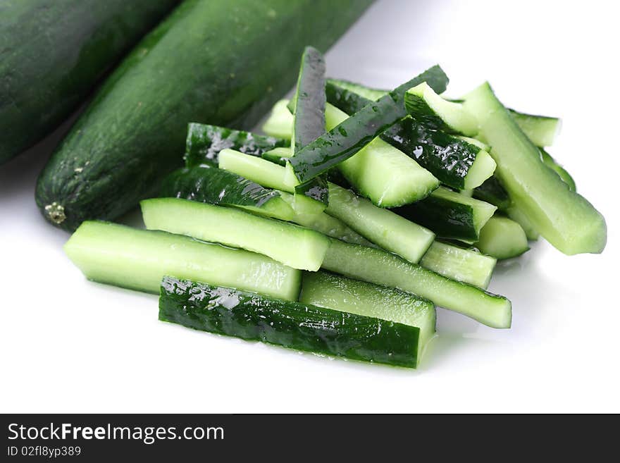 Close up of cucumber pieces isolated over white background.