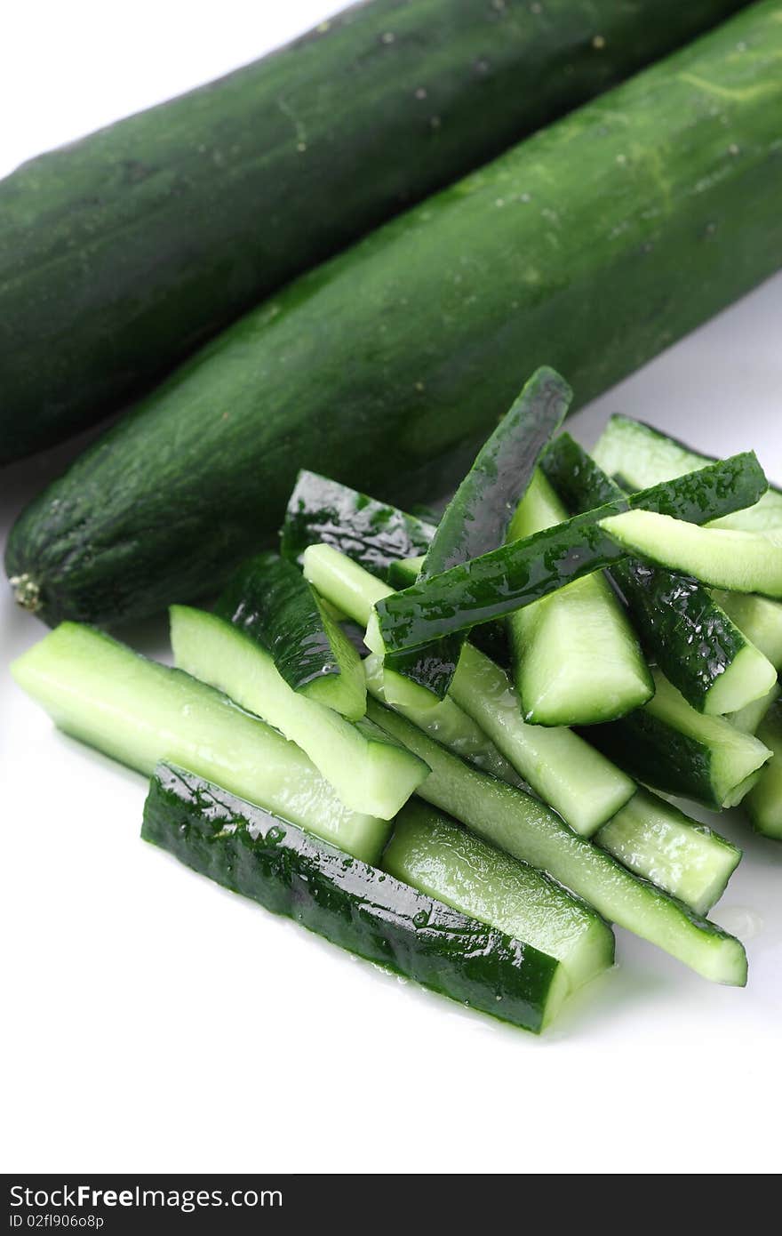 Close up of cucumber pieces isolated over white background.