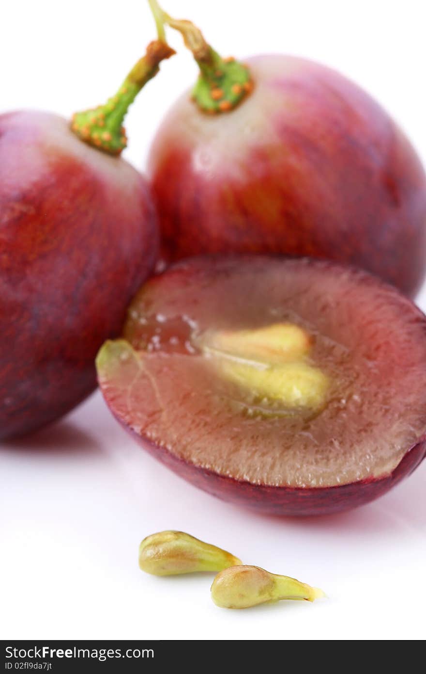 An half and fullness grapes with seeds isolated over white background.