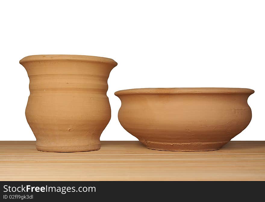 Two coiled clay pots on the mat