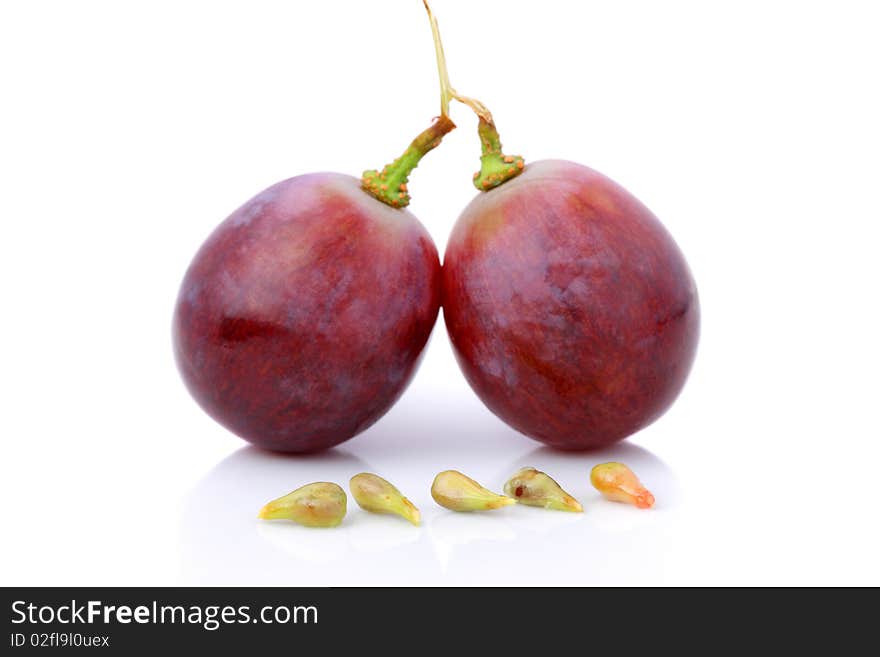 An half and fullness grapes with seeds isolated over white background.