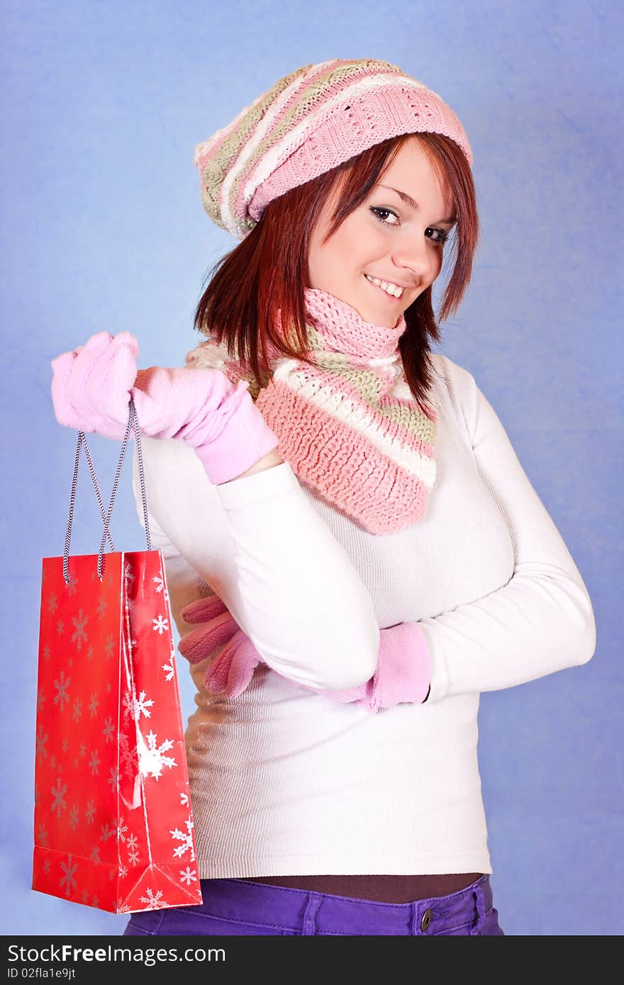 Beautiful young girl holding a red shopping paper bag. Beautiful young girl holding a red shopping paper bag