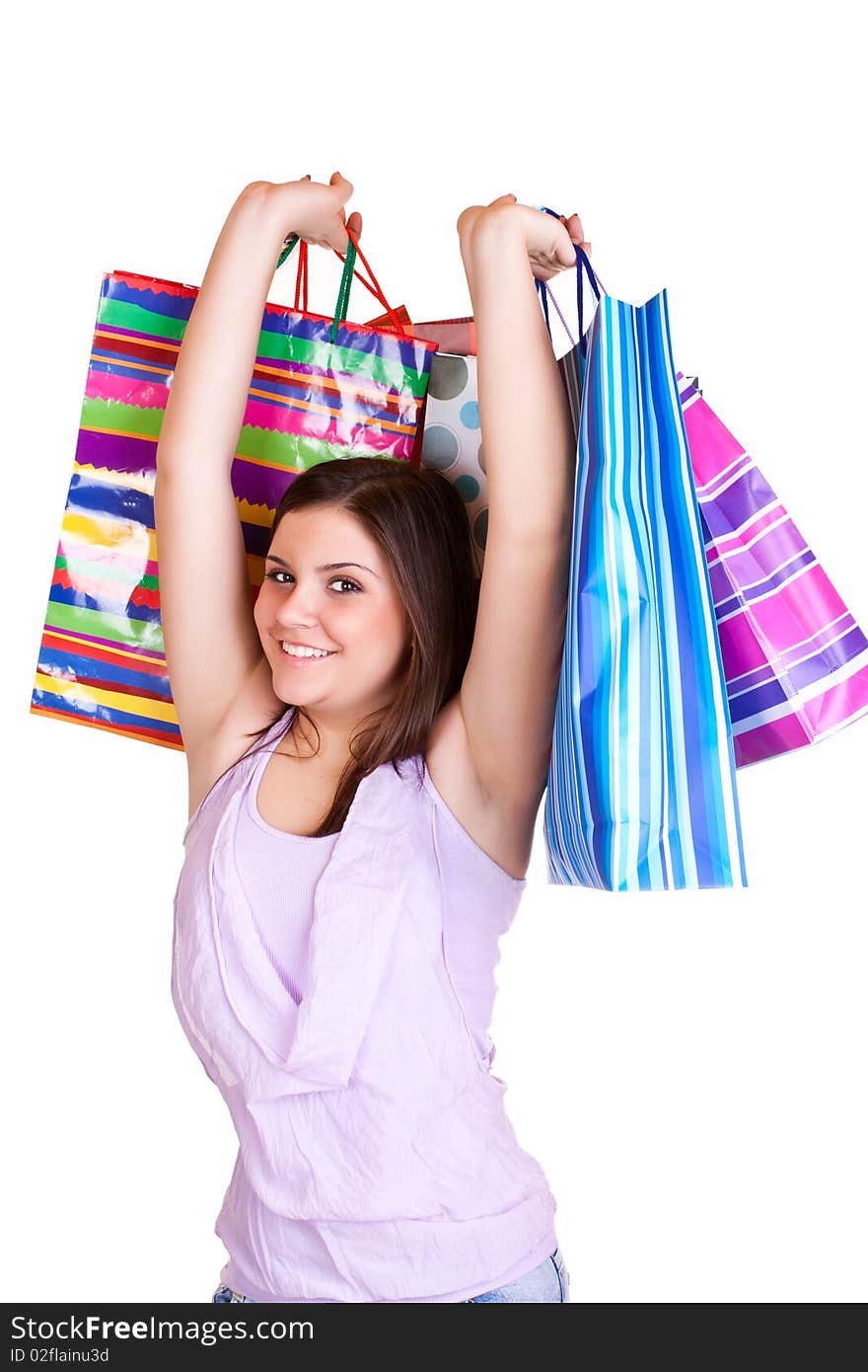 Beautiful young woman standing and holding colorful paper bags. Beautiful young woman standing and holding colorful paper bags