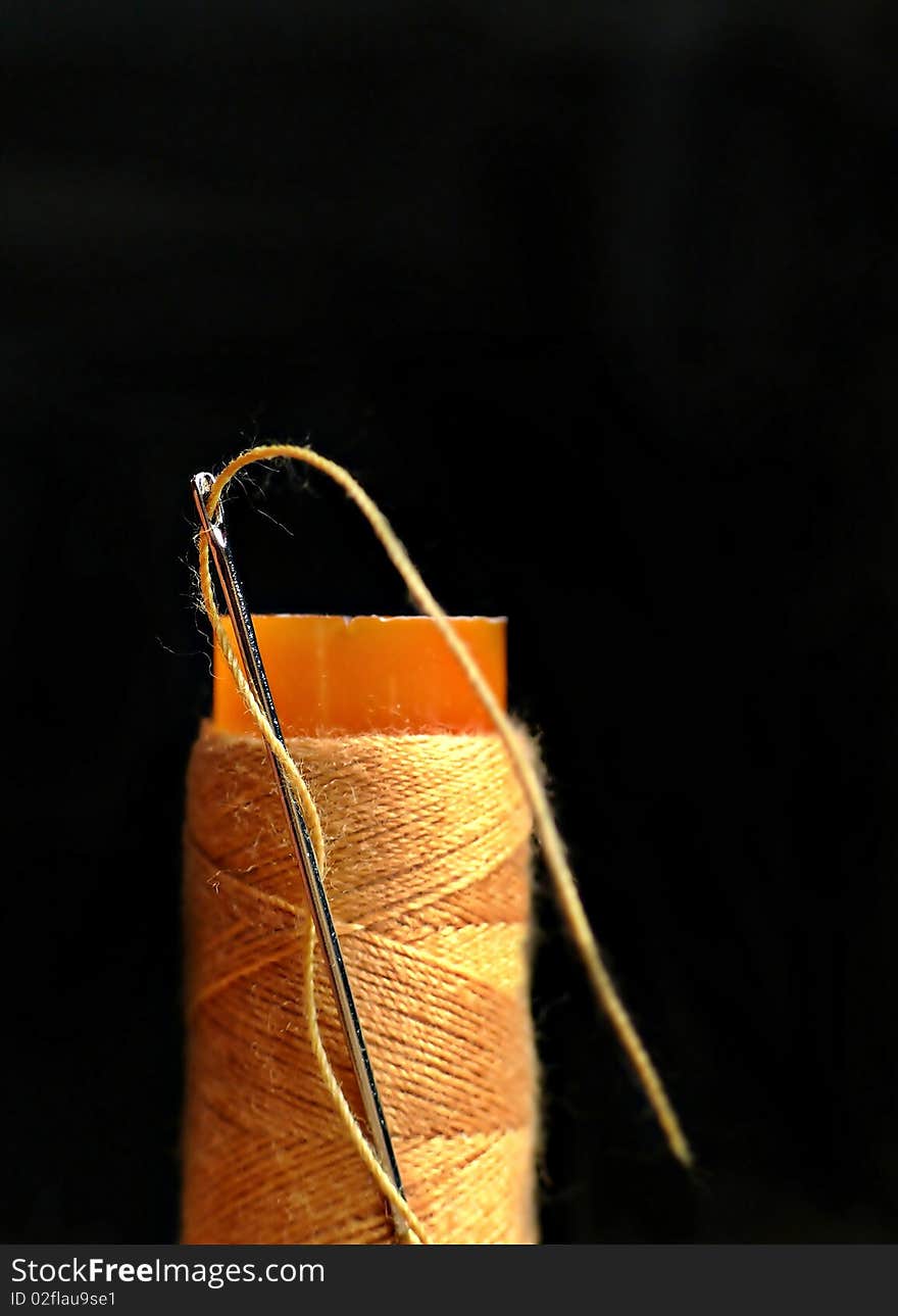 Bobbin of orange thread