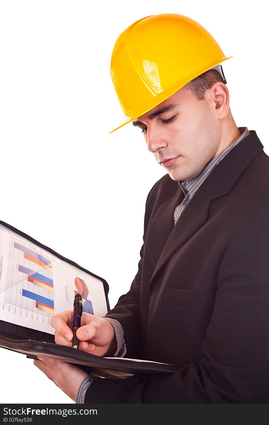 Young attractive businessman with helmet on his head holding documents. Young attractive businessman with helmet on his head holding documents