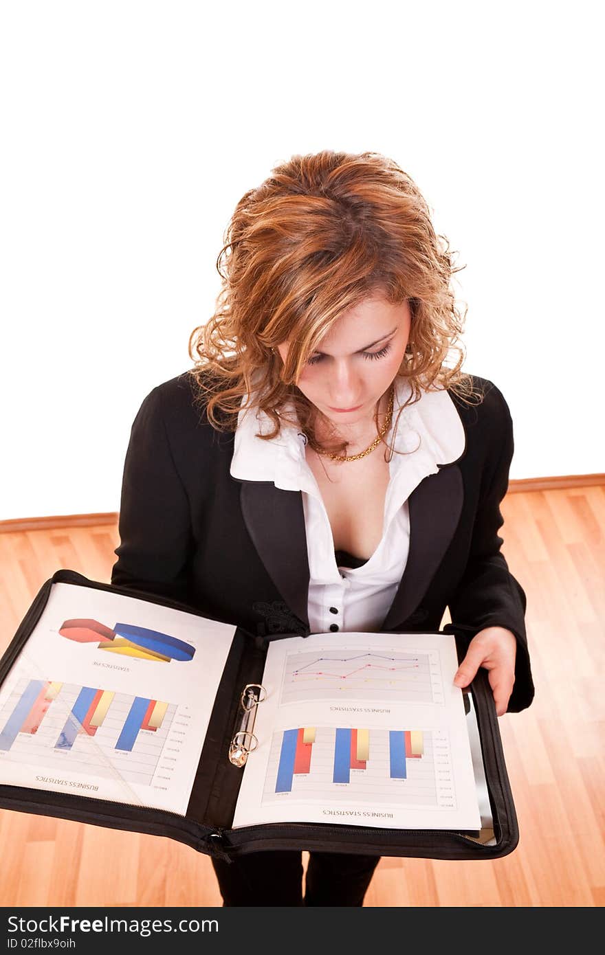 Young attractive blond businesswoman holding and looking documents. Young attractive blond businesswoman holding and looking documents