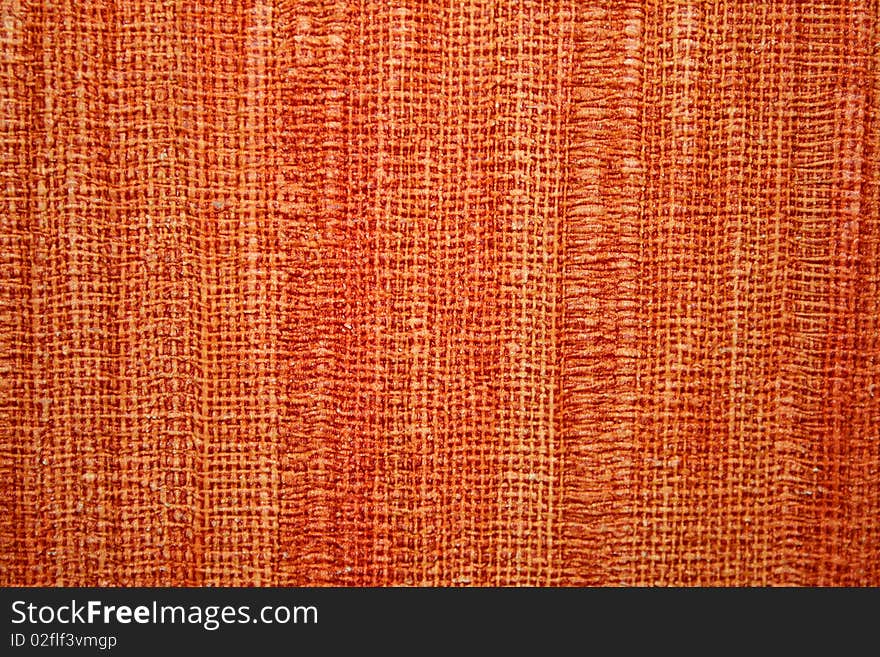 Texture of coarse cloth, orange-colored interlocking fibers