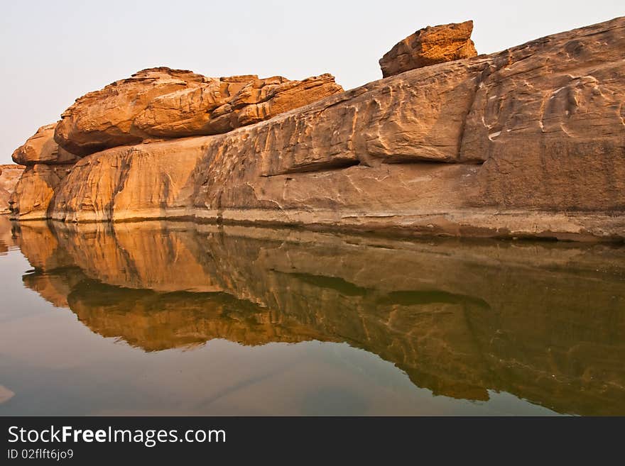 Rock and reflection in clear water