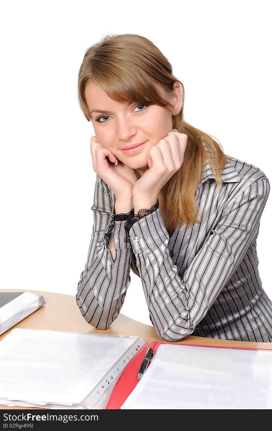 Portrait of the thinking young woman  with a folder sitting at a table on a white background. Portrait of the thinking young woman  with a folder sitting at a table on a white background