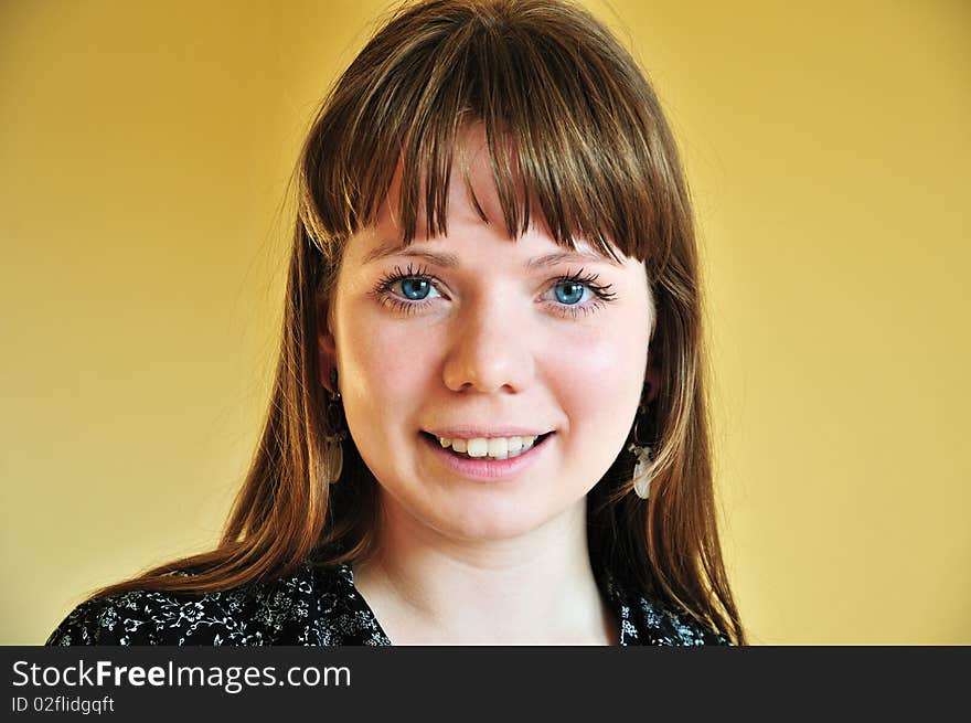 Portrait of cheerful girl with yellow background