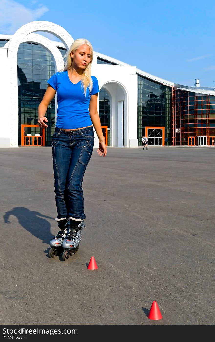 Young blonde woman rolling on the street. Young blonde woman rolling on the street