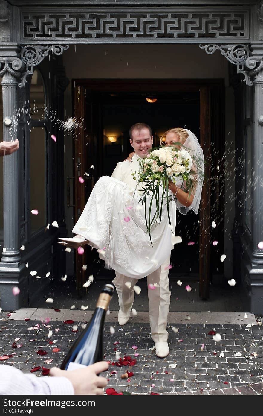 Newly wed couple being showered in rose petals. Newly wed couple being showered in rose petals