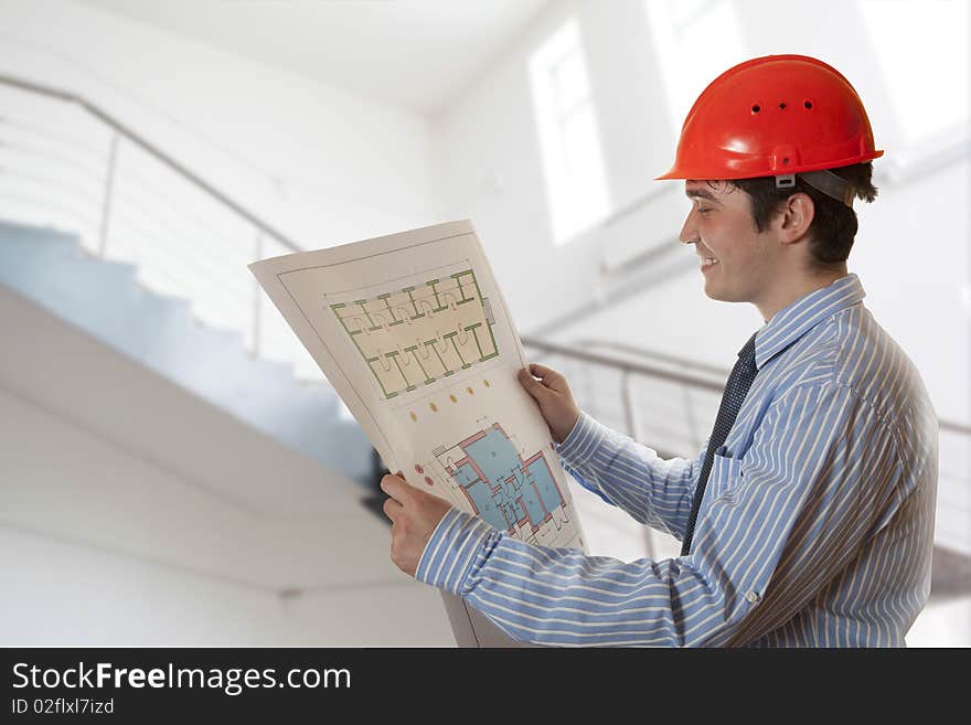 Architect looking at a new construction plan. Architect looking at a new construction plan