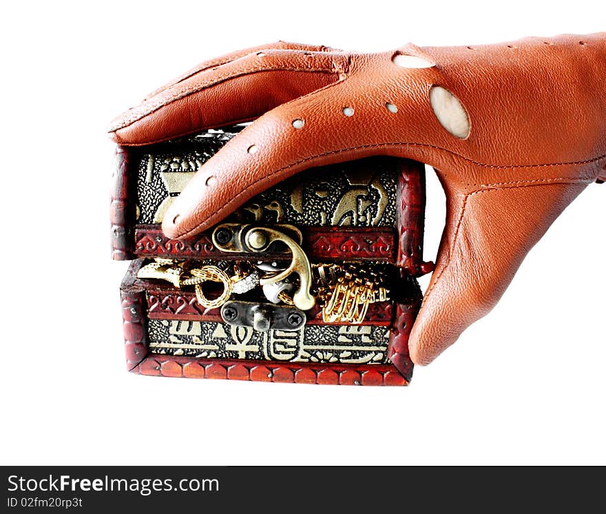 Hand in glove holding casket with jewelry