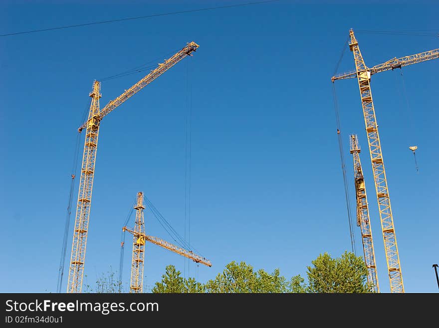 Four hoisting cranes and the sky