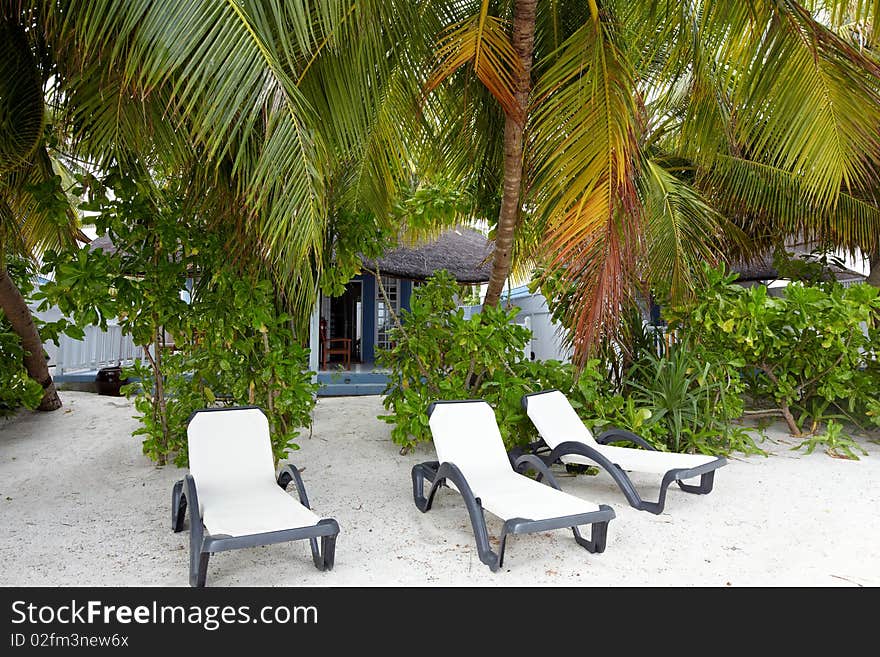 Chase lounge on beach sand.