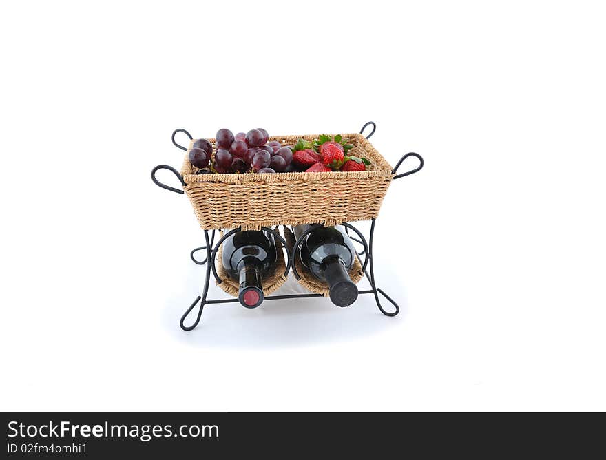 Bottle of vine with fruits in straw basket. Bottle of vine with fruits in straw basket