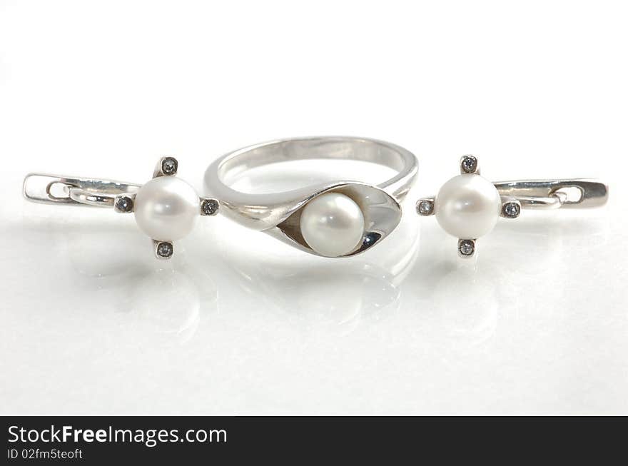 Closeup view of a ring and earrings with pearls