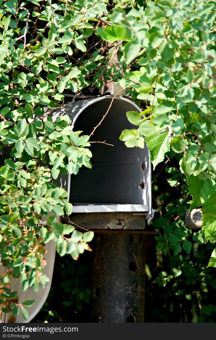 A mailbox along a country road toward a small village. A mailbox along a country road toward a small village.