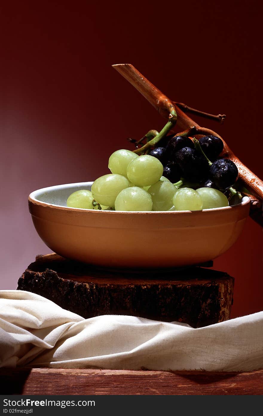 Still life of black and white grapes in a bowl. Still life of black and white grapes in a bowl