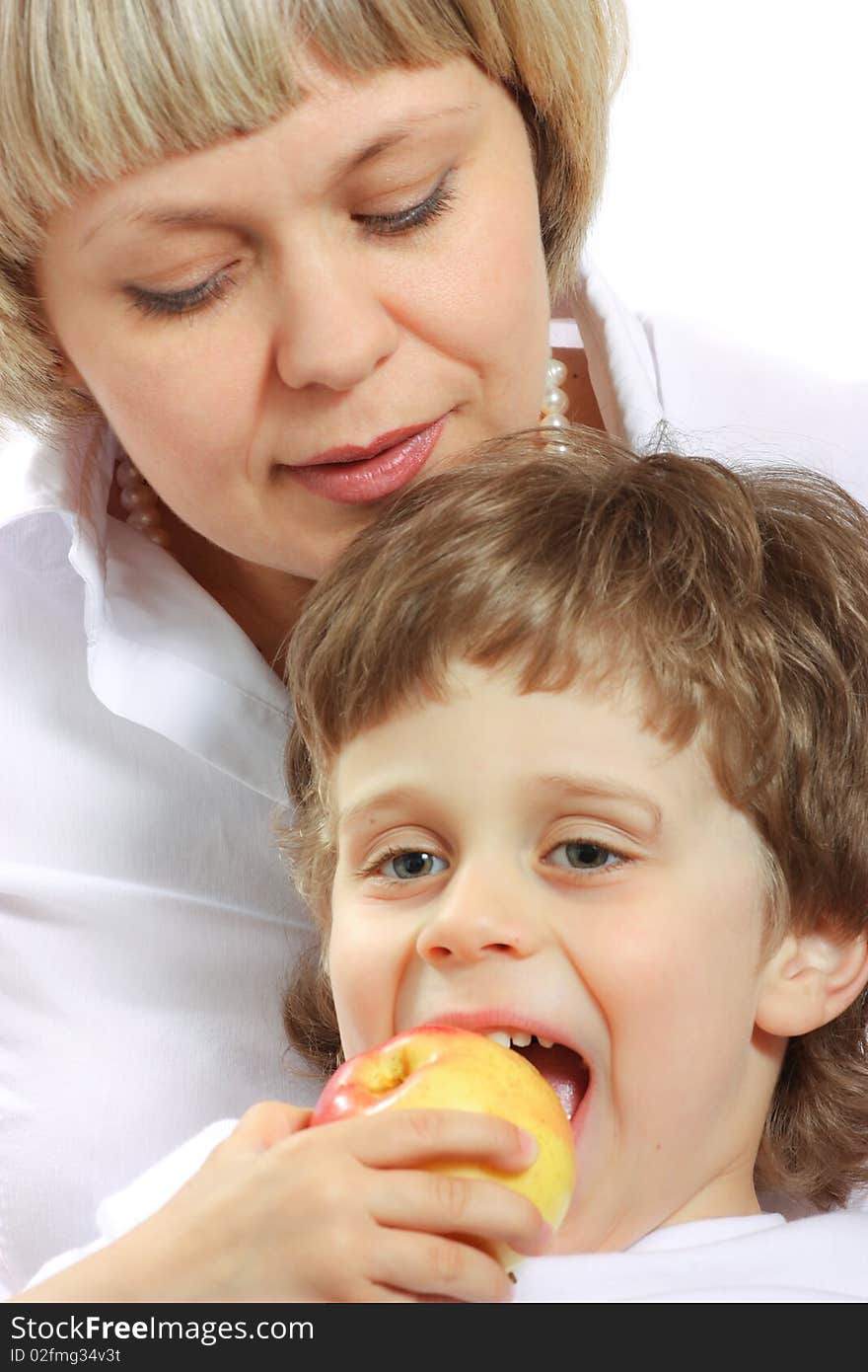 Woman and boy eating apple