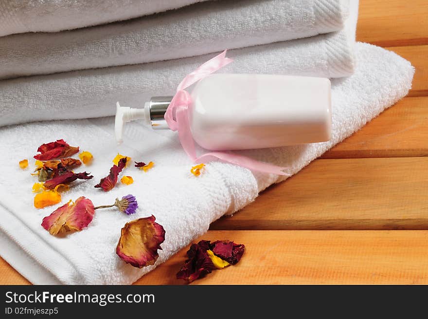 White towels with dry flowers on bench. White towels with dry flowers on bench.