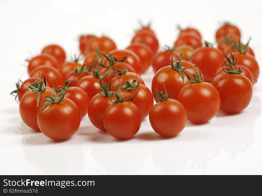 Crimson tomatoes on white background image