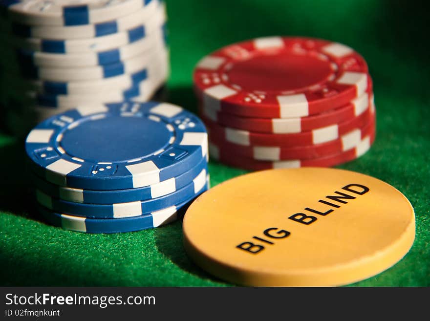 Poker chips on green on green background. Poker chips on green on green background.