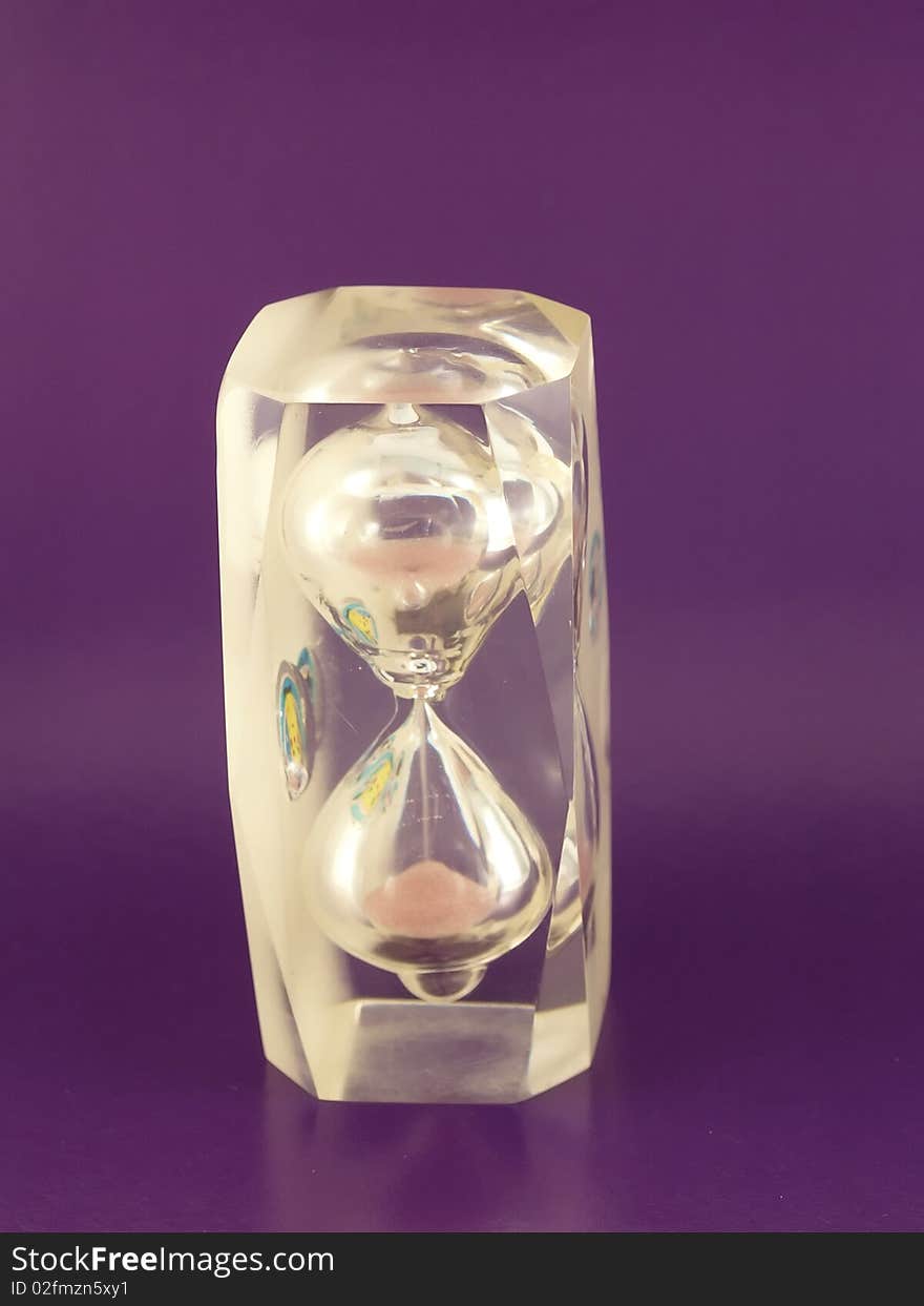 Sand-glass on the violet background.