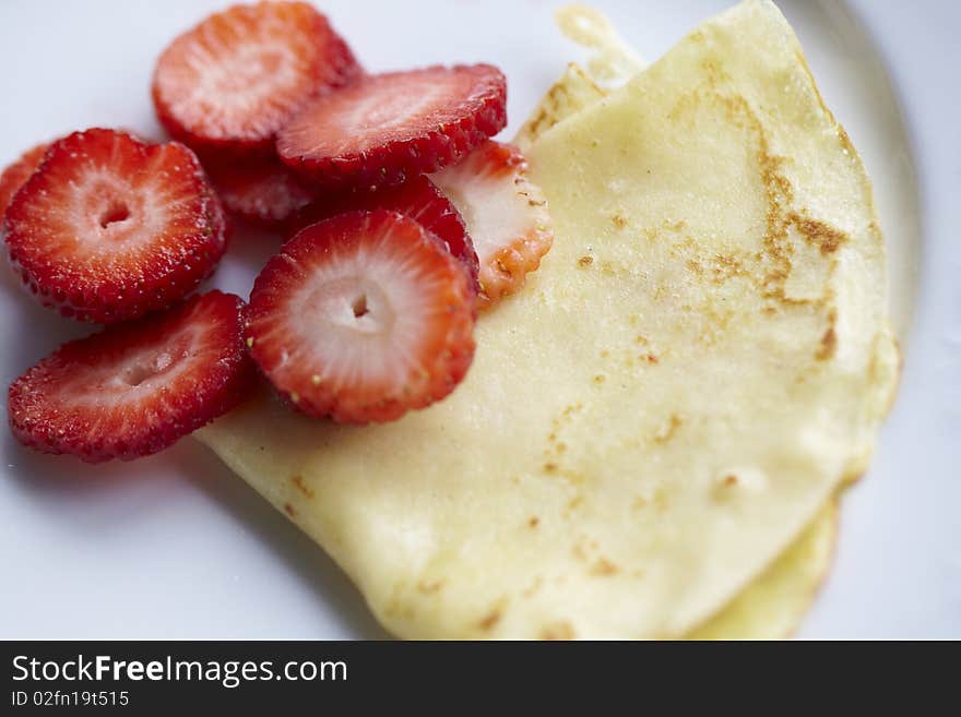 Thin pancake or crepes with sliced strawberries. Thin pancake or crepes with sliced strawberries