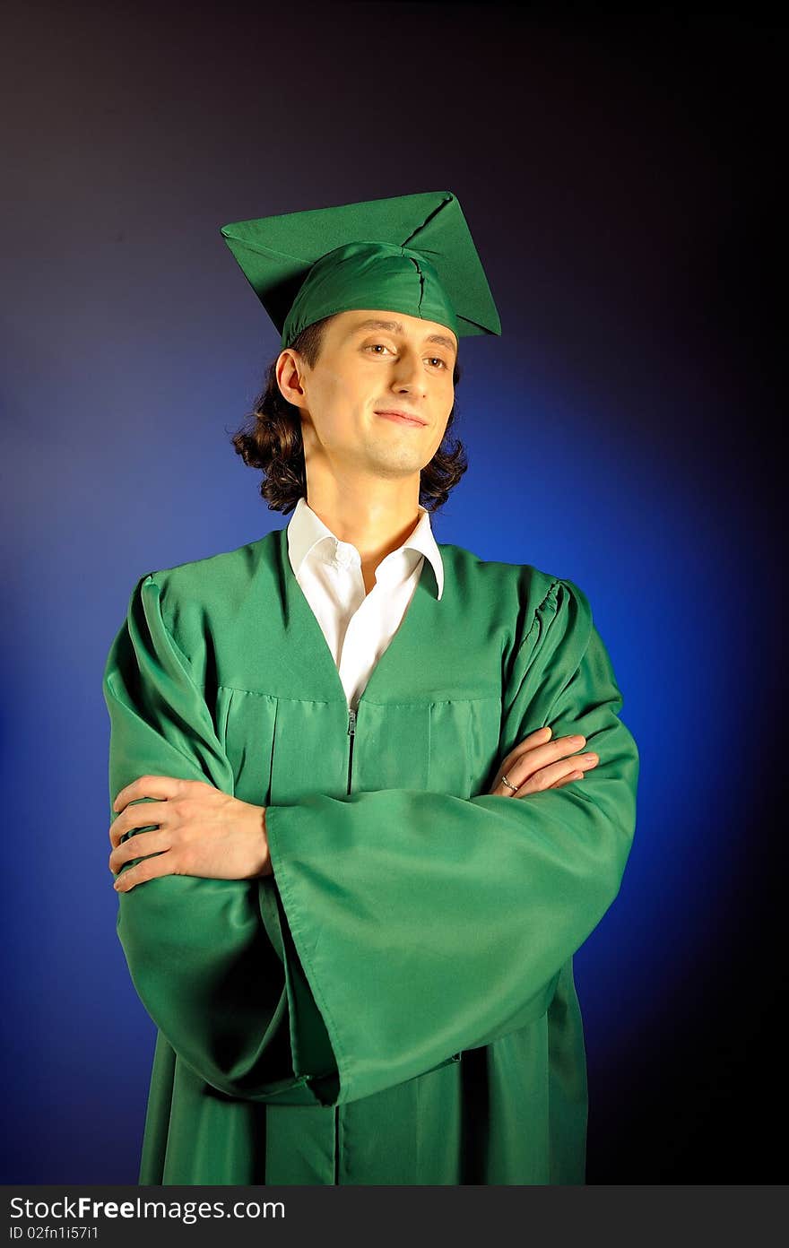 Portrait of a succesful man on his graduation day in green clothes and a hat