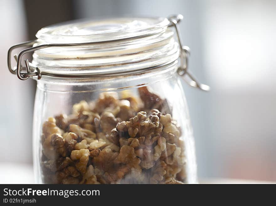 Glass jar with walnuts for storage