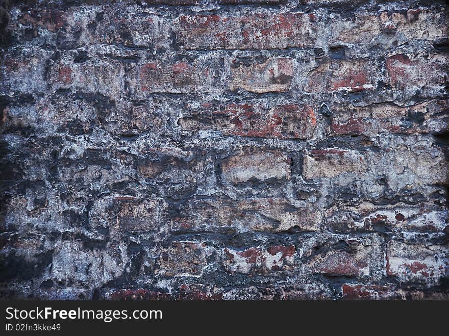 Old grey brick wall - background in grunge style