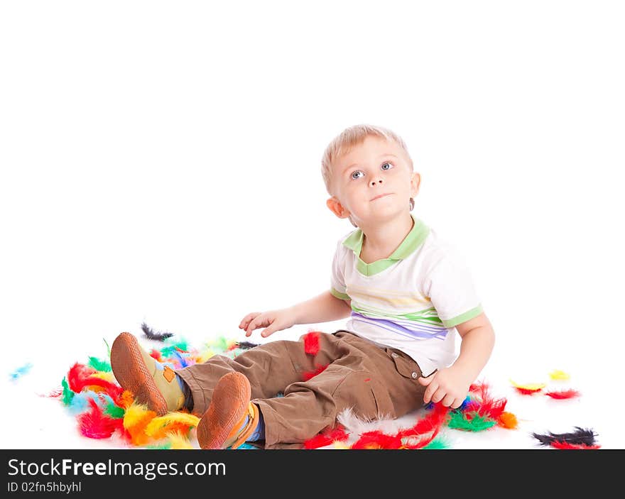 Little Boy Is Sitting On A Flow With Feathers