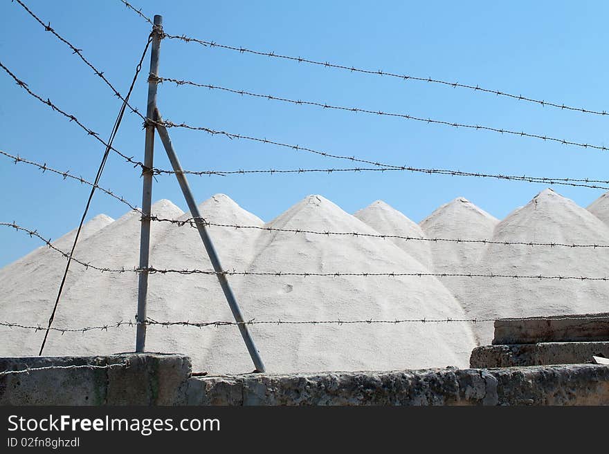 Salt mine and wires against blue sky