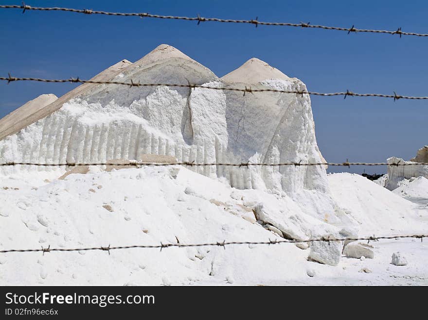 Heap of raw salt against blue sky