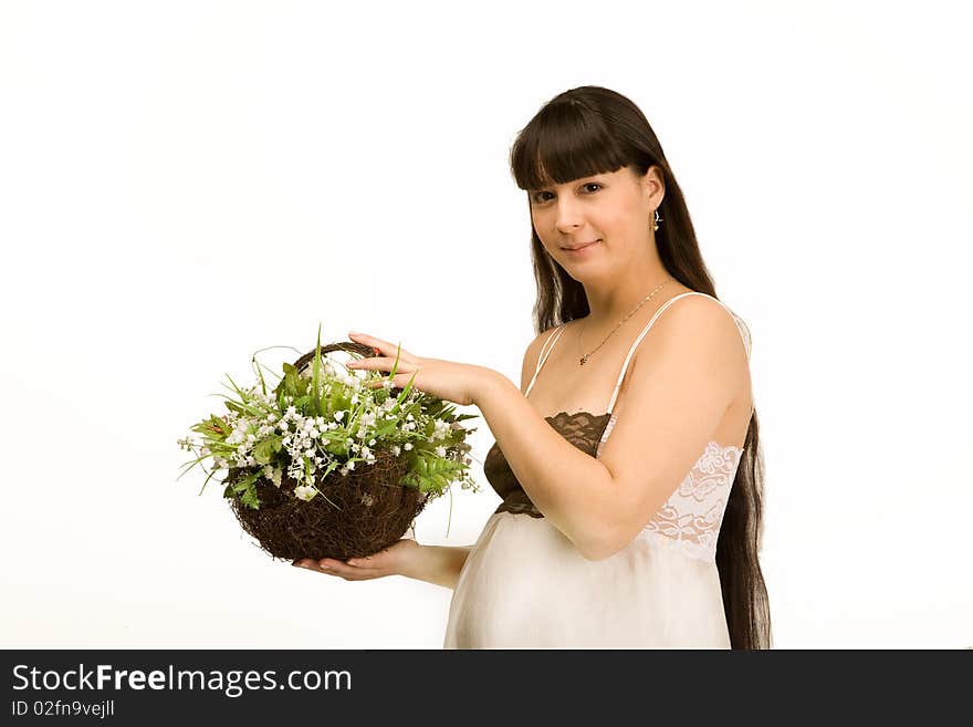 A pregnant woman holding a basket of lilies of the valley. A pregnant woman holding a basket of lilies of the valley