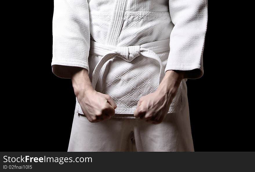 Man in kimono on black background. Man in kimono on black background