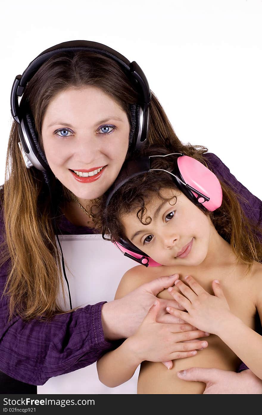 Woman with her mulatto girl listening to music. Woman with her mulatto girl listening to music