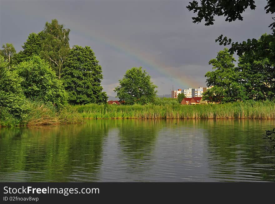 Pond a rainbow near city